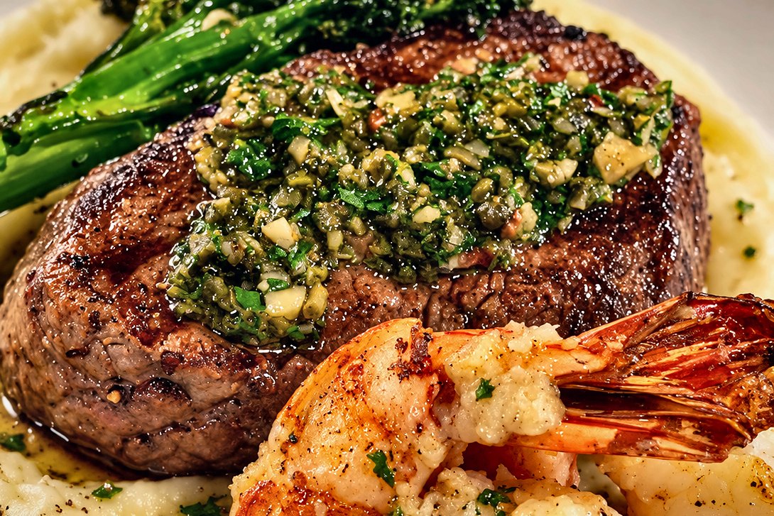 Gulf shrimp and steak with chimichurri, plated by Chef Fassi in Galveston