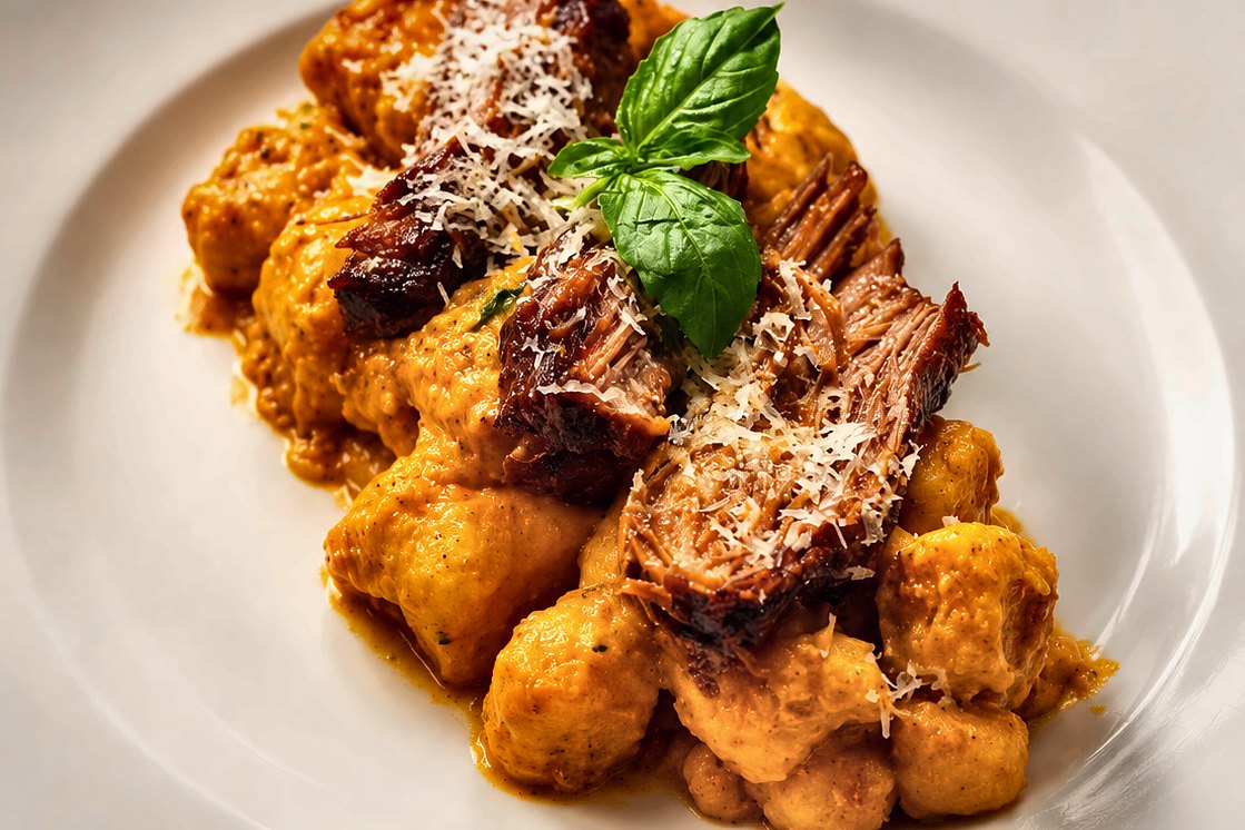 Braised short rib over gnocchi, plated by Chef Fassi in The Heights