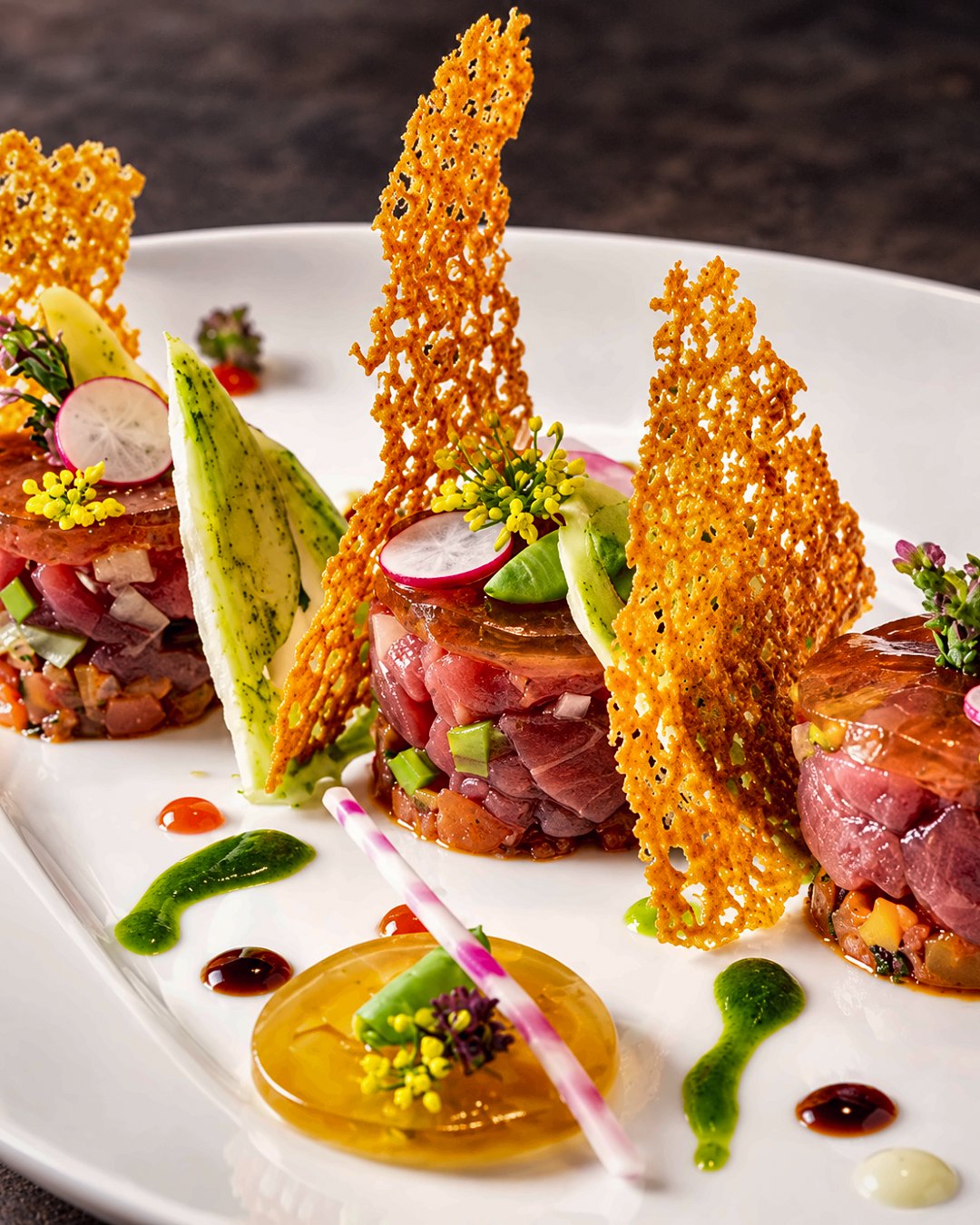 Composed tasting course with tuna, parmesan tuile and herb oil by Chef Martin Fassi